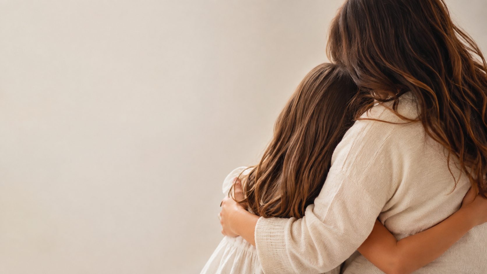 A mother embracing her daughter